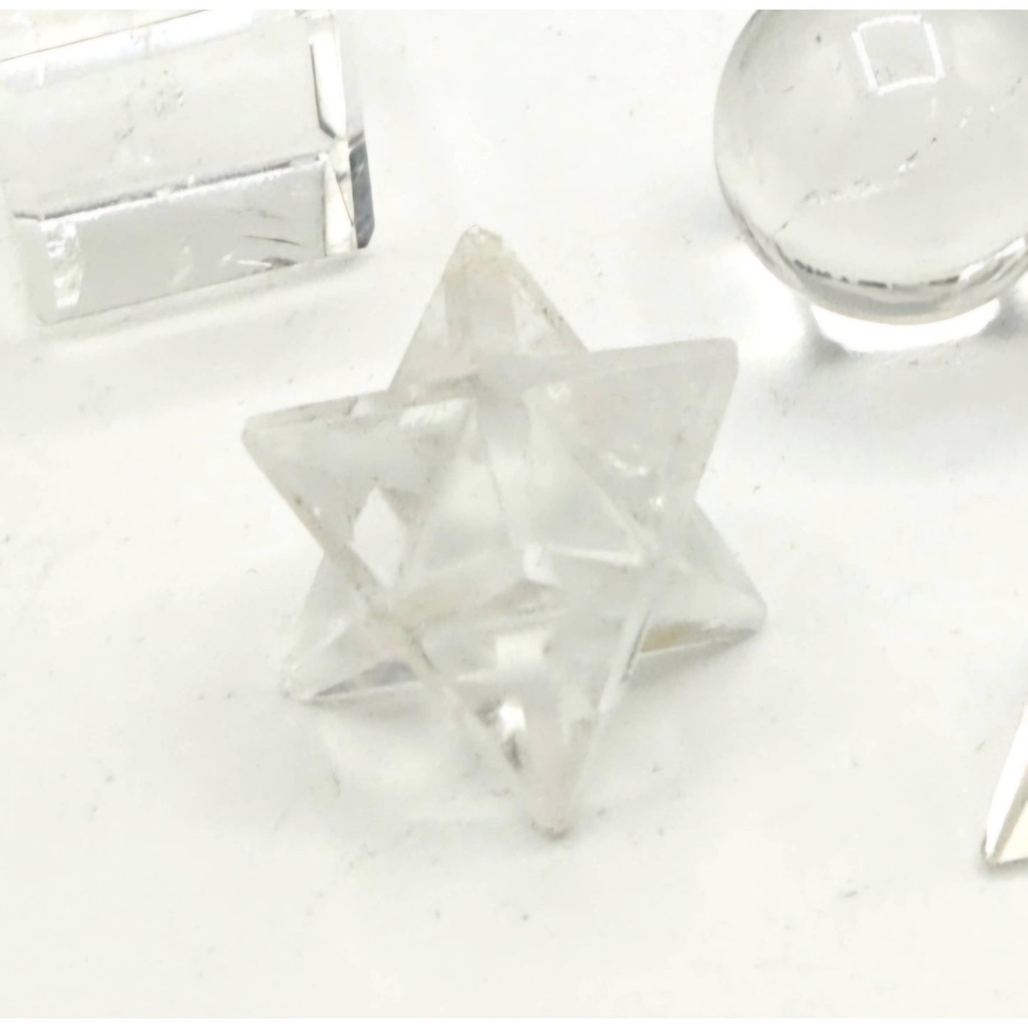 Clear Quartz Sacred Geometry Set – 7 Carved Crystals + Merkaba & Sphere with Grid & Pouch